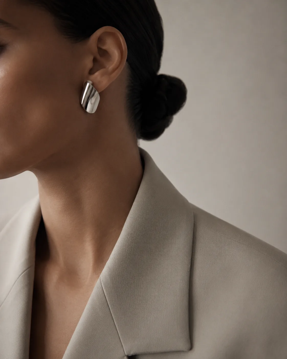 Sculptural earring with a tailored blazer detail